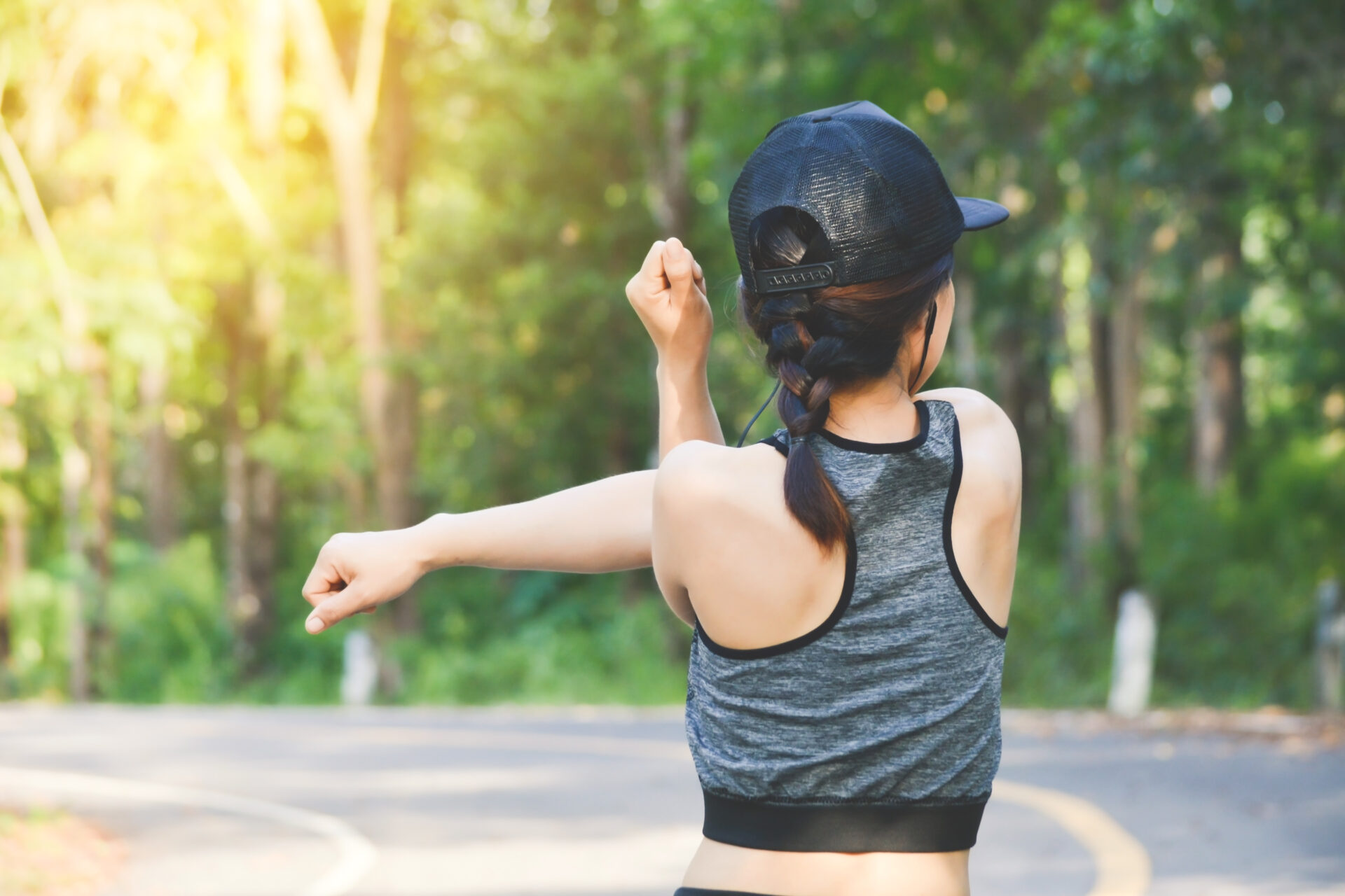 Person stretching in sportswear, illustrating sweat management use during exercise