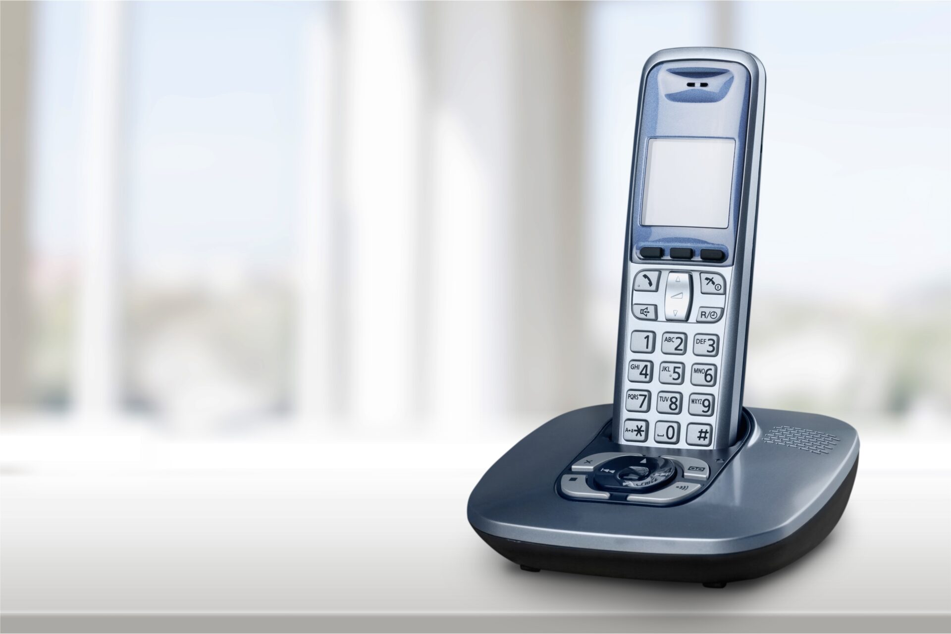 Cordless telephone handset on a charging base, representing an application of nonwoven separator materials for industrial nickel-metal hydride batteries and other secondary batteries