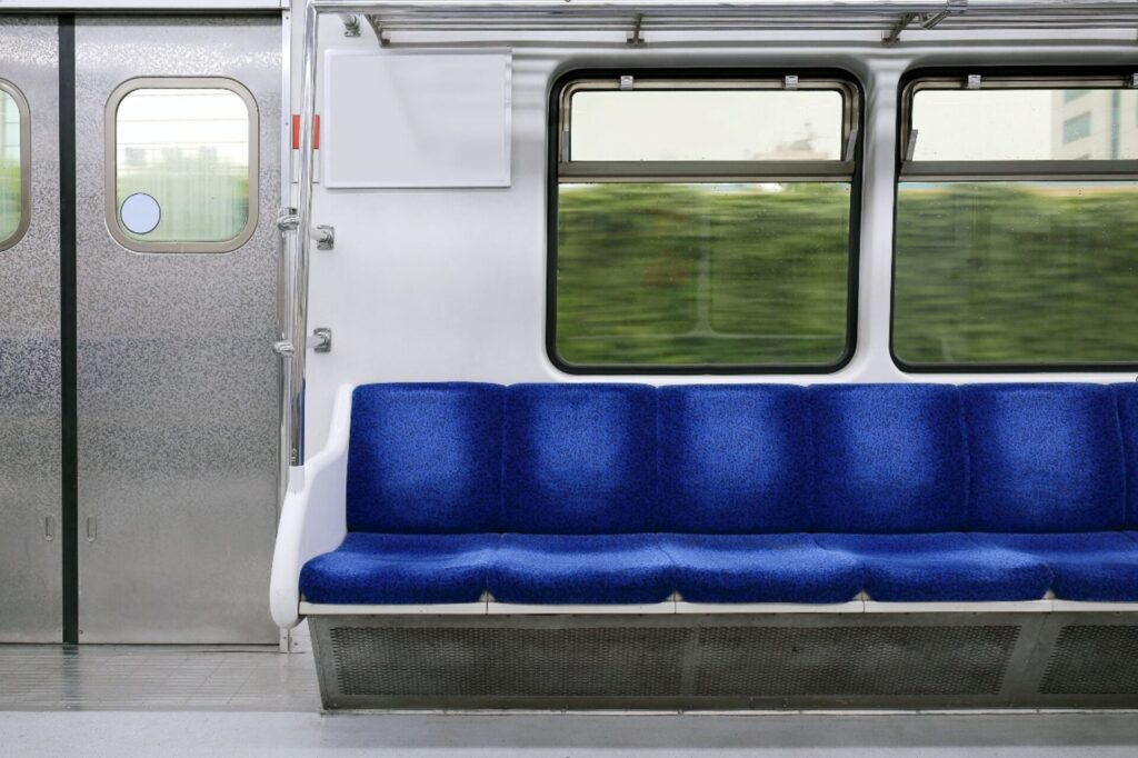 Interior view of a train with seating and cabin structure (use case for backing materials in railway seating)